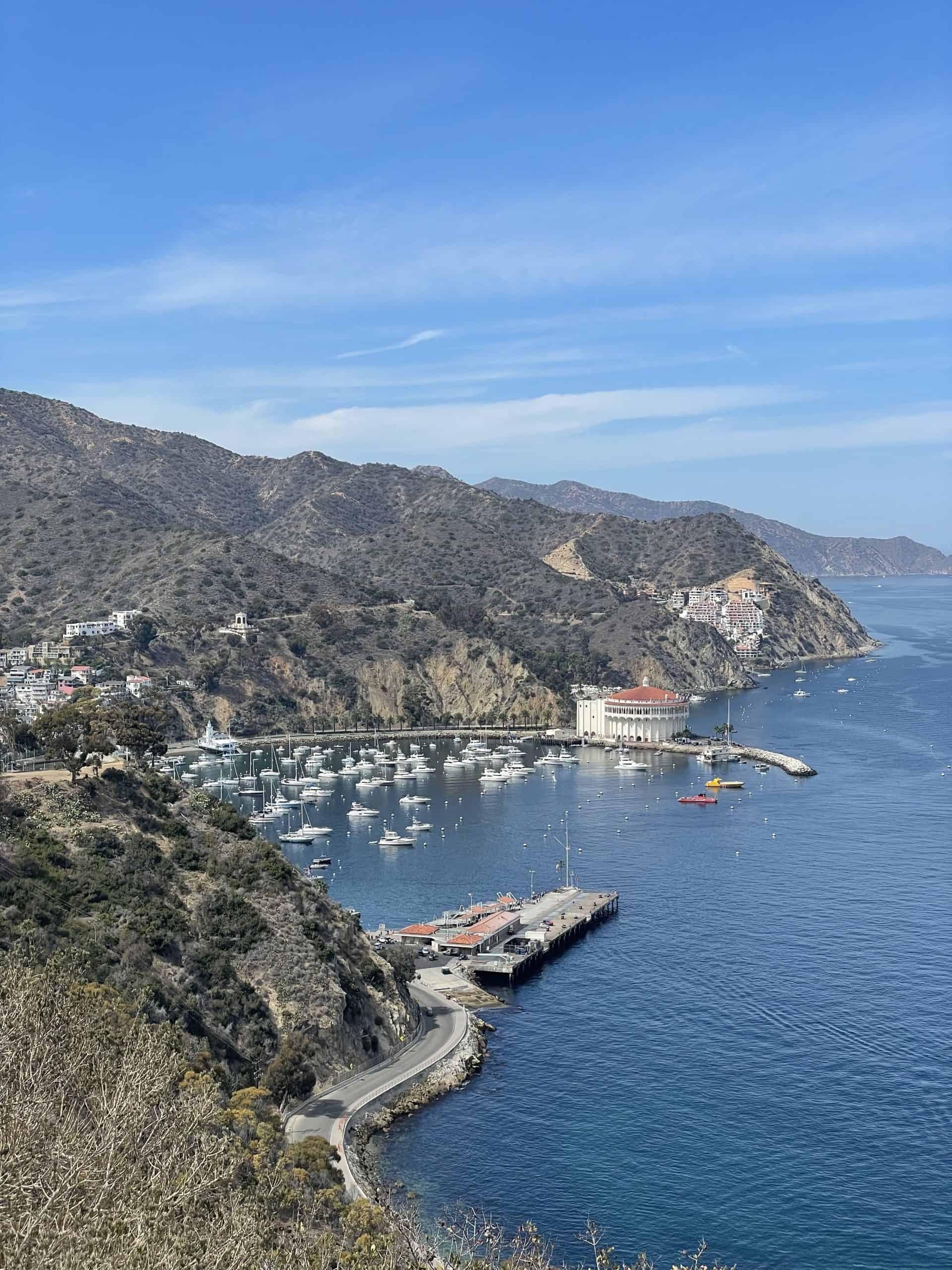catalina island with boats docked in the harbor and hills in the background