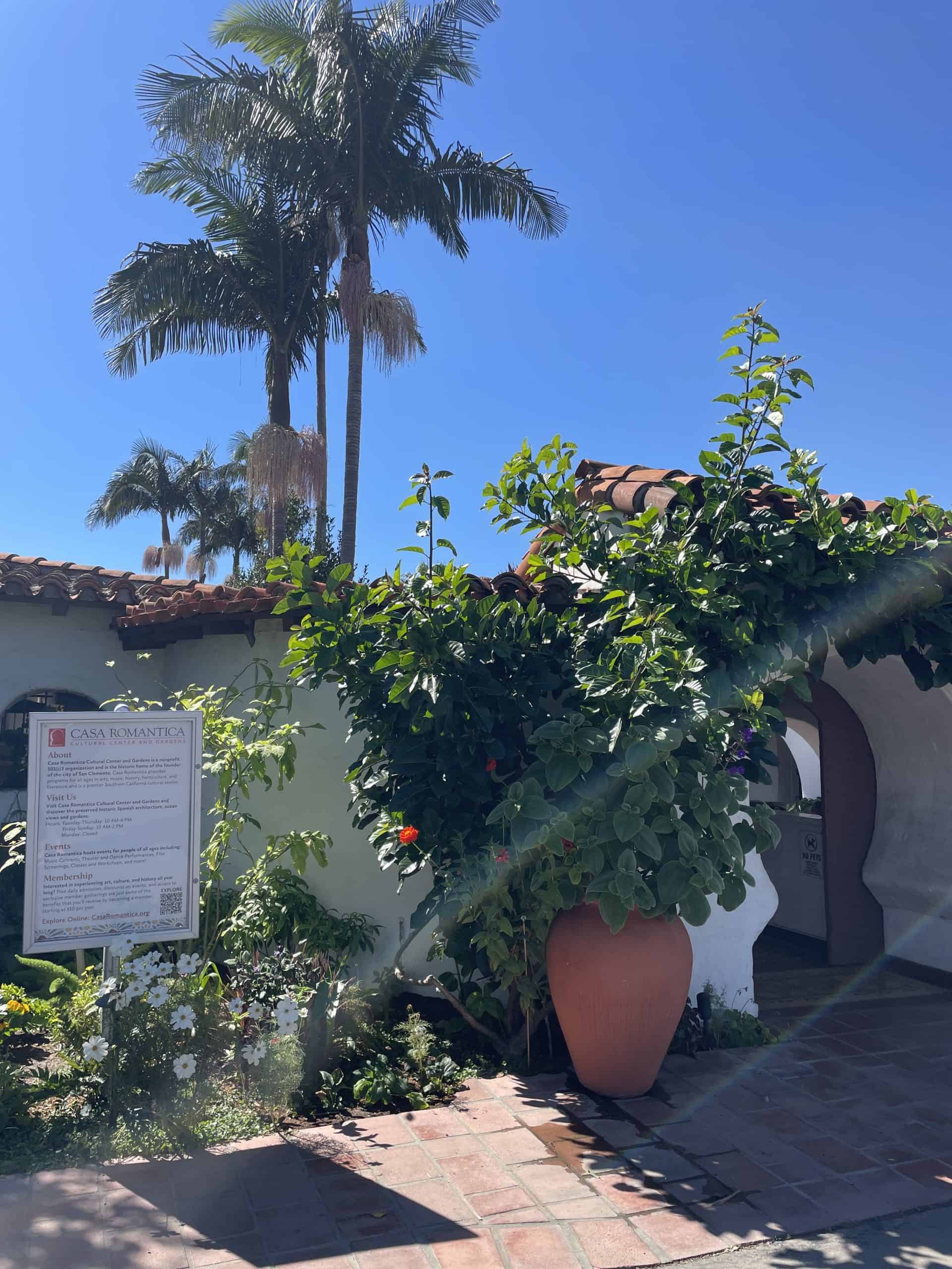 from of the Casa Romantica building in San Clemente with greenery and a plant in a clay vase