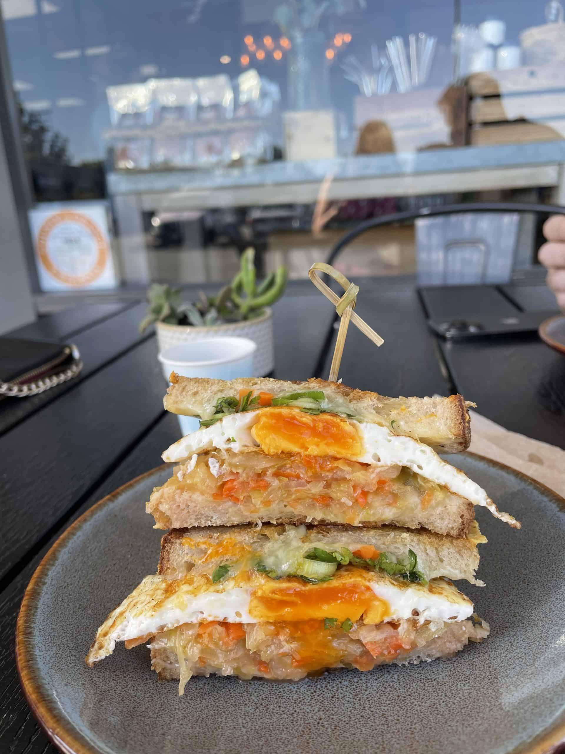 a breakfast sandwich with a fried egg and sauerkraut from Ferm Farm in Orange County