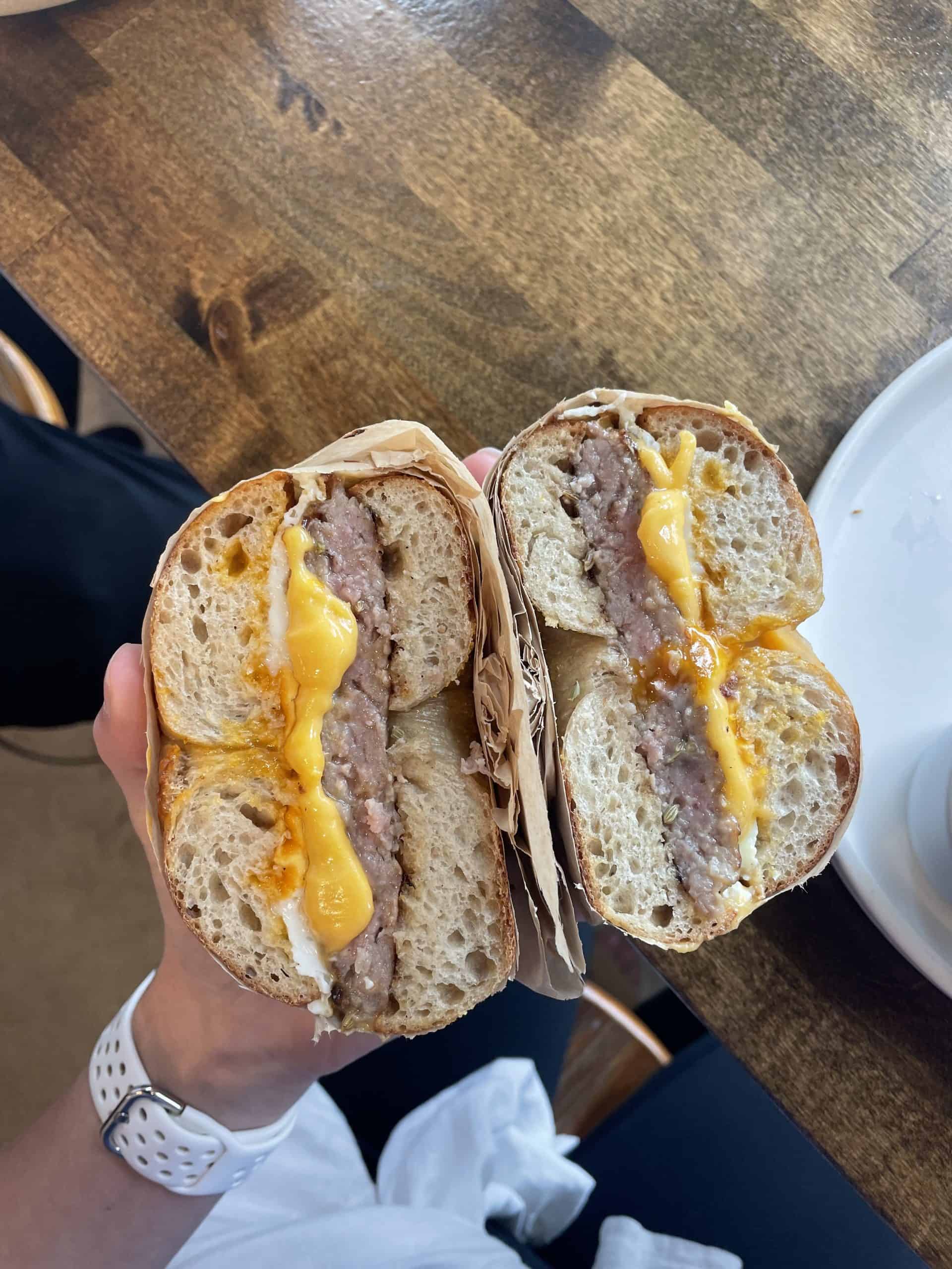 sausage and egg bagel in half on sourdough bagels from a breakfast spot in Orange County