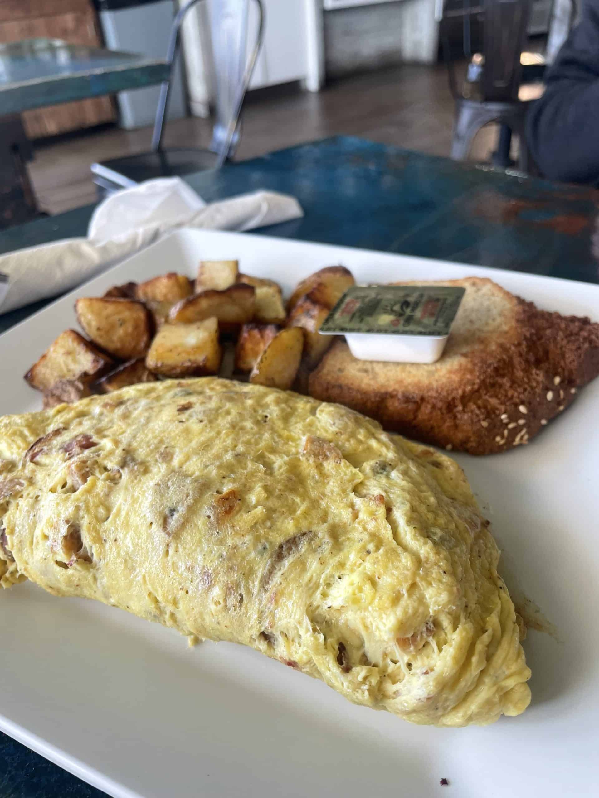 an omelette with roasted potatoes and gluten free bread at Craft Kafe in St. Pete