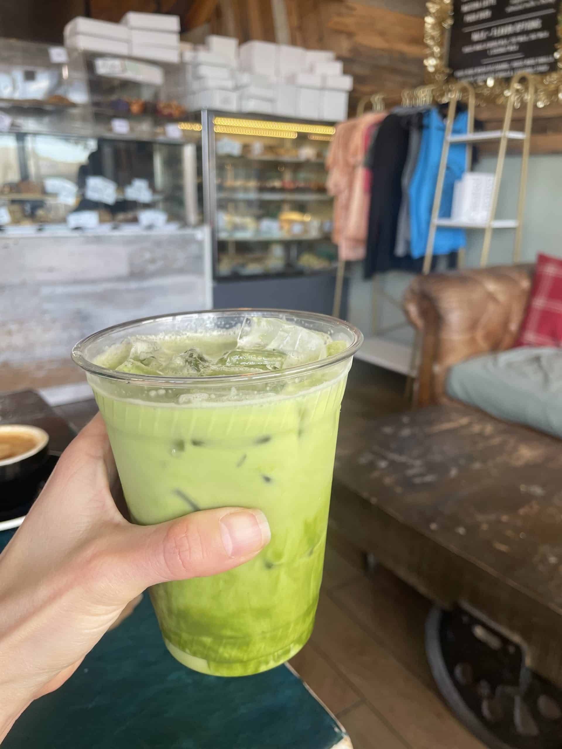 an iced matcha latte in a plastic cup