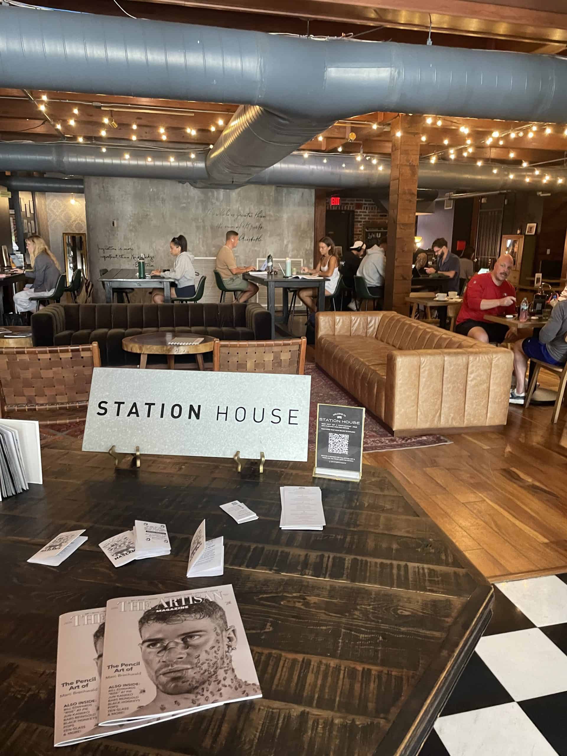 people sitting inside of a coffee bar with a Station House sign in St. Pete