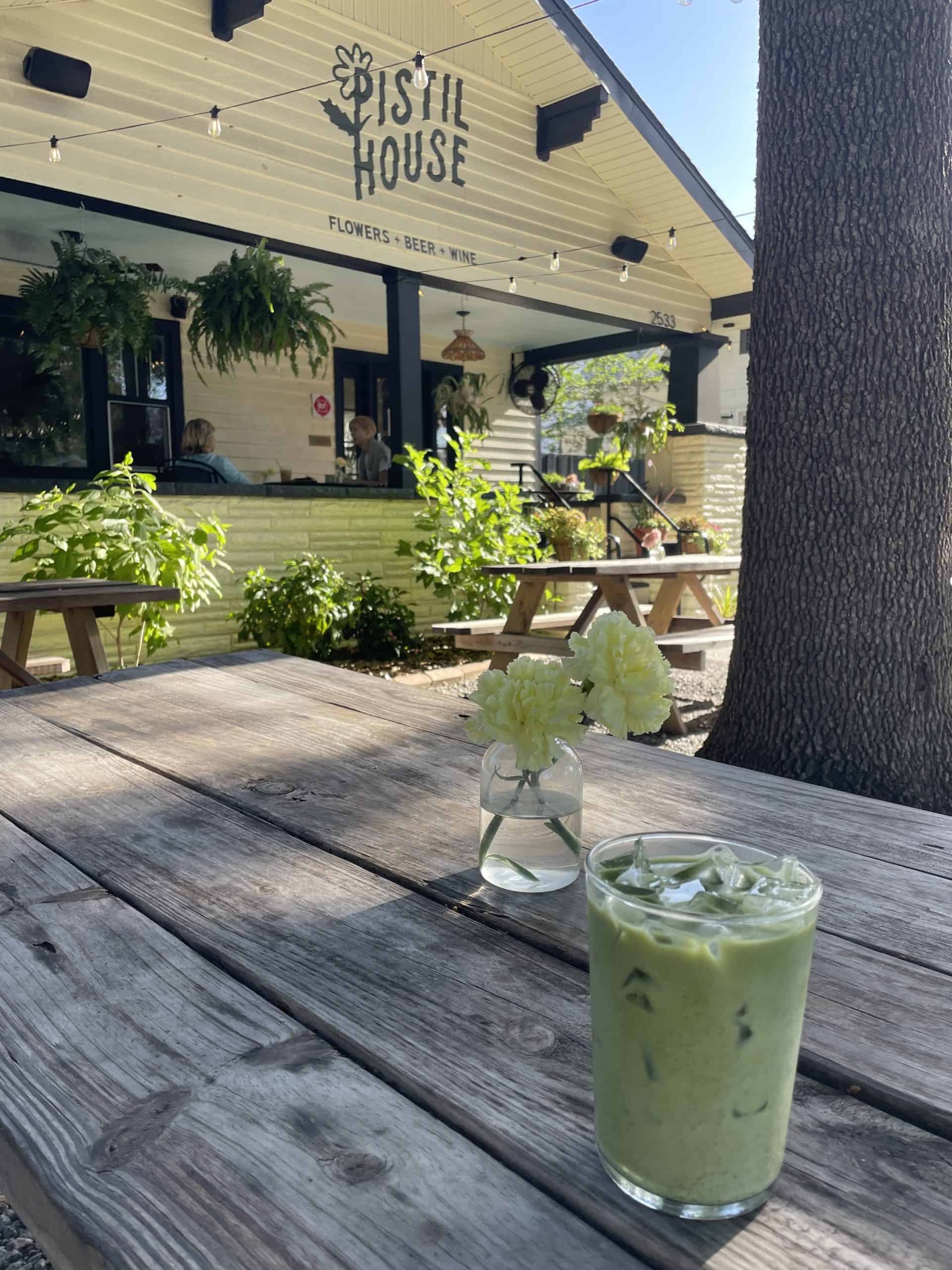 iced matcha latte on a picnic table in front of Pistil House in St. Petersburg, FL.